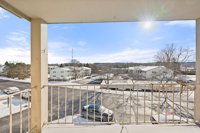 view of snow covered back of property