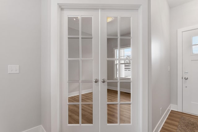 interior space with wood-type flooring, french doors, and plenty of natural light