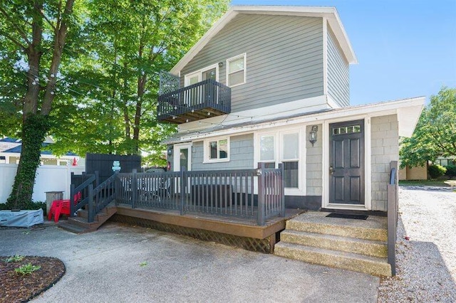 front facade featuring a balcony and a deck