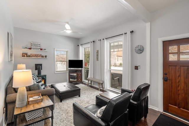 living room featuring dark wood-type flooring and ceiling fan