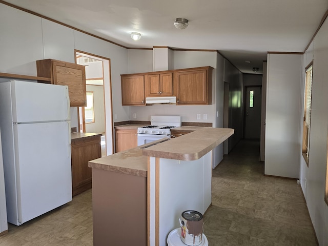 kitchen featuring crown molding, a kitchen island, and white appliances