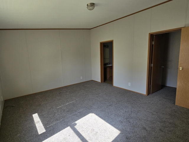 carpeted spare room featuring crown molding