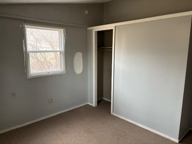 unfurnished bedroom with carpet and a closet