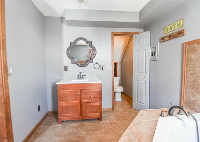 bathroom with vanity, a tub to relax in, and toilet