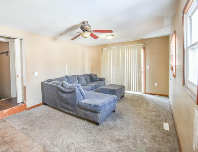 living room with ceiling fan and carpet flooring