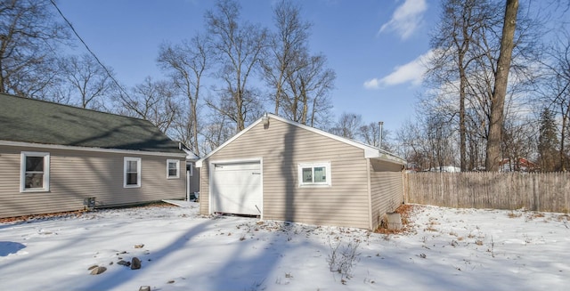 exterior space with a garage and an outdoor structure