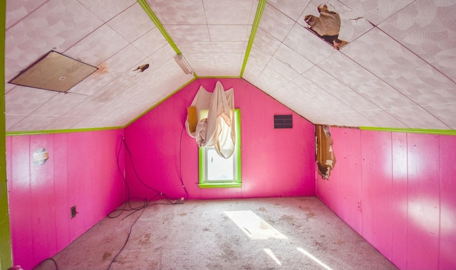 additional living space featuring lofted ceiling and light carpet