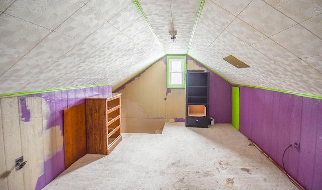 bonus room featuring vaulted ceiling and carpet flooring