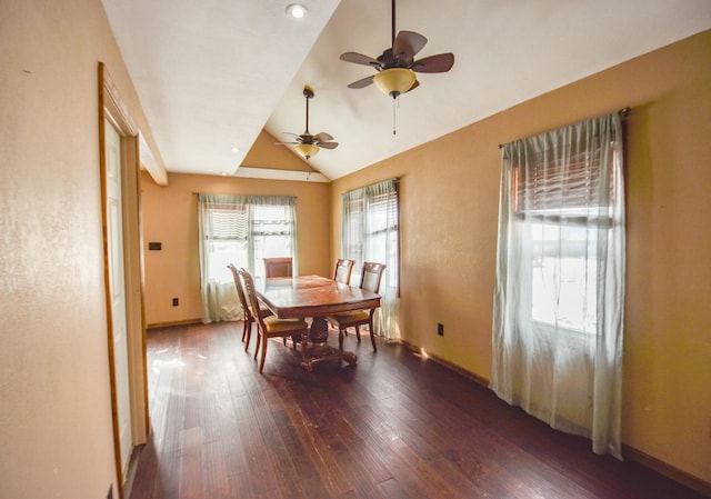 dining area with dark wood-type flooring and vaulted ceiling