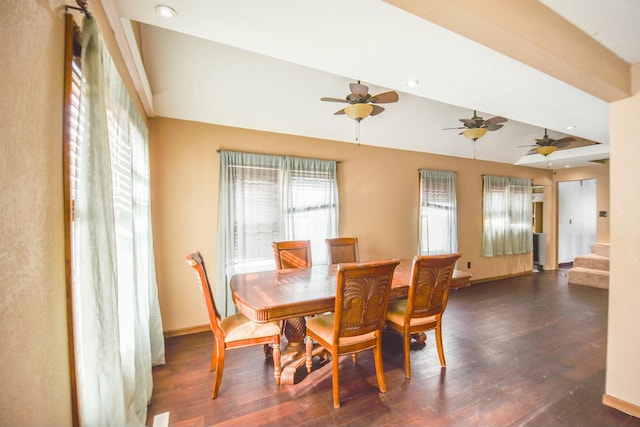 dining room featuring dark hardwood / wood-style flooring and vaulted ceiling