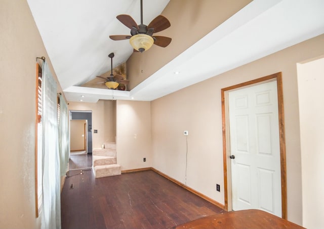 spare room featuring dark wood-type flooring, high vaulted ceiling, and ceiling fan