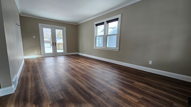 spare room featuring crown molding, dark hardwood / wood-style floors, and french doors