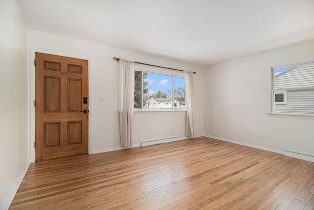 entryway with a baseboard heating unit and light hardwood / wood-style flooring