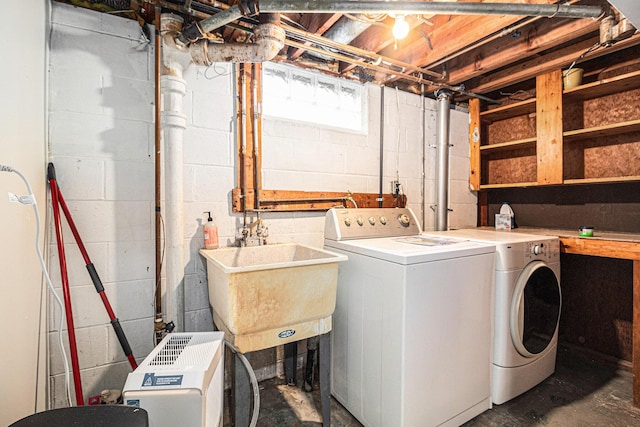 laundry area featuring washing machine and clothes dryer and sink