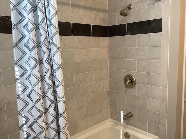 bathroom with shower / bath combo with shower curtain