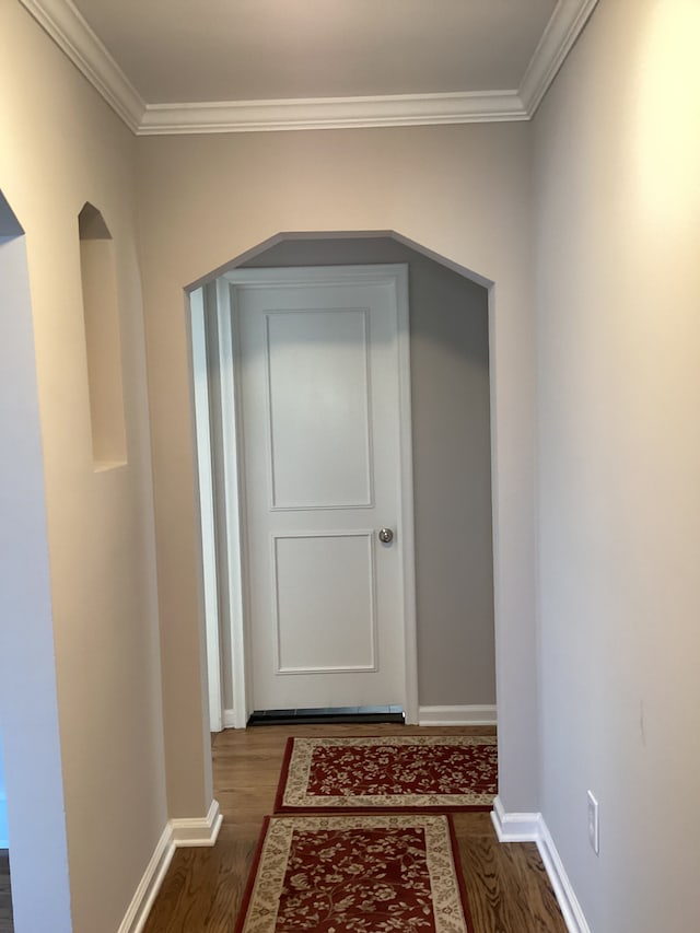 hall featuring ornamental molding and dark hardwood / wood-style floors