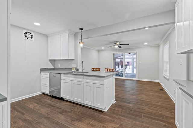 kitchen with sink, white cabinetry, hanging light fixtures, stainless steel dishwasher, and kitchen peninsula