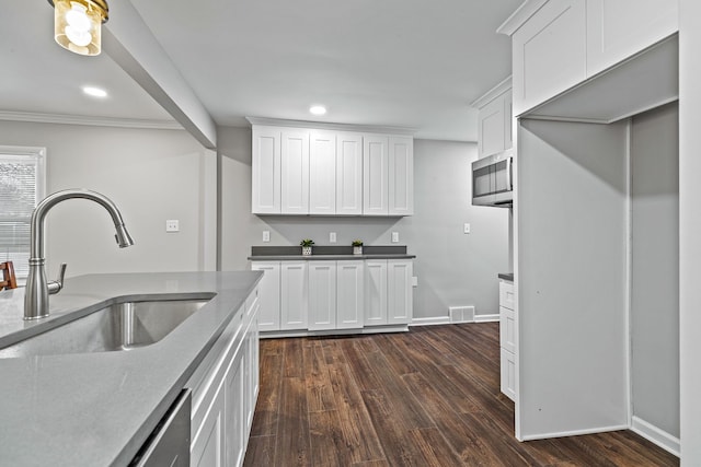 kitchen featuring sink, dark wood-type flooring, and white cabinets