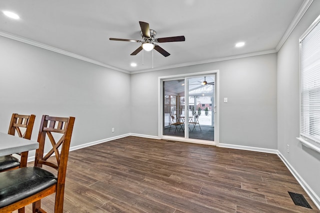 dining area featuring crown molding, dark wood-type flooring, and ceiling fan