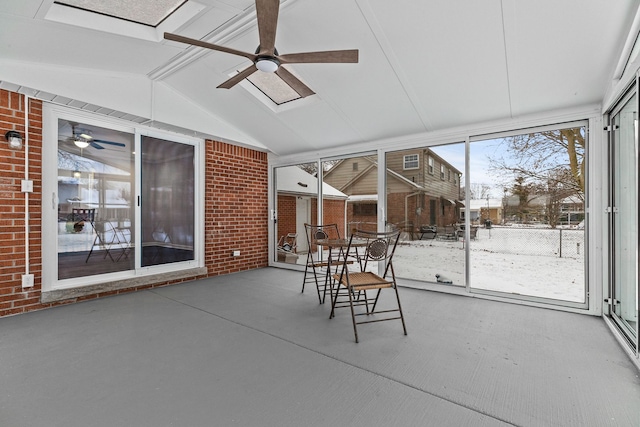 unfurnished sunroom featuring lofted ceiling with beams and ceiling fan