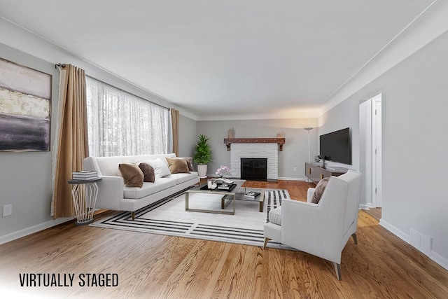 living room with hardwood / wood-style floors and a fireplace