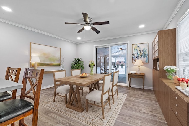 dining space with crown molding, ceiling fan, and light wood-type flooring