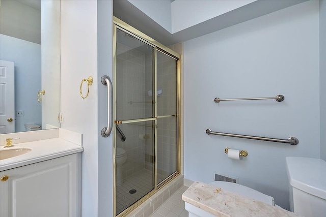 bathroom featuring walk in shower, vanity, and toilet