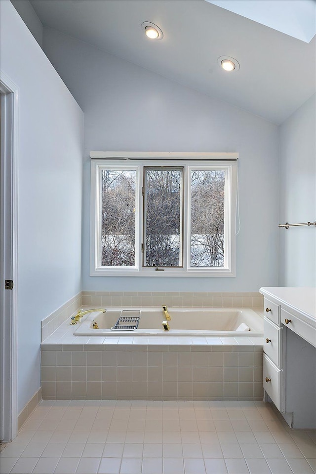 bathroom featuring lofted ceiling and vanity