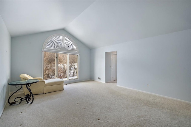 interior space featuring light colored carpet and vaulted ceiling