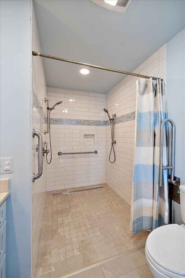 bathroom with vanity, curtained shower, and toilet