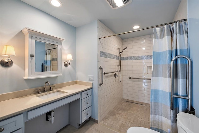 bathroom featuring vanity, toilet, and walk in shower