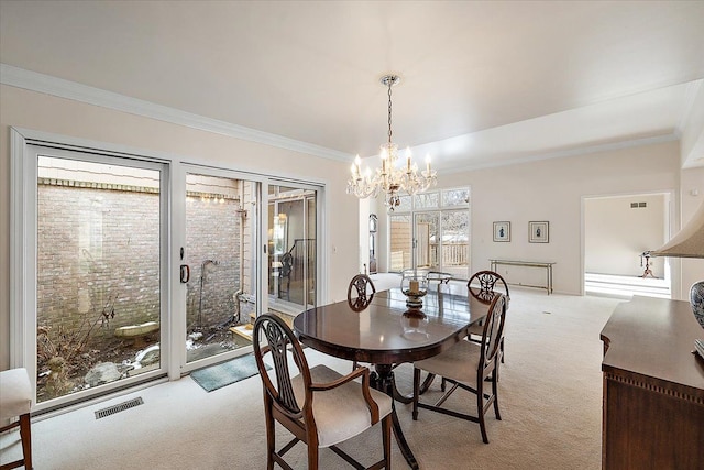 dining room with light carpet, crown molding, and an inviting chandelier