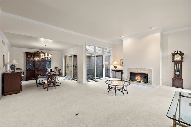 carpeted living room with an inviting chandelier, ornamental molding, and a premium fireplace