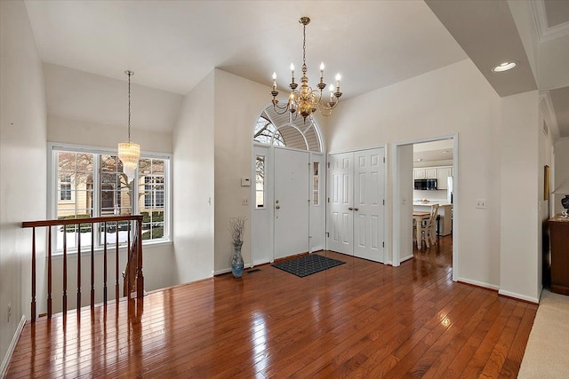 entryway featuring an inviting chandelier and hardwood / wood-style flooring