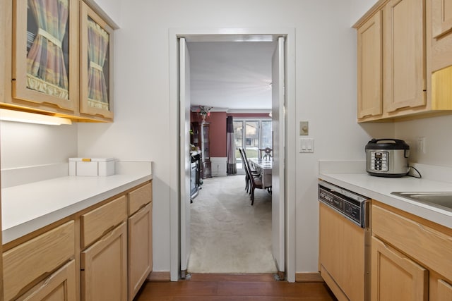 kitchen featuring dishwasher and light brown cabinets