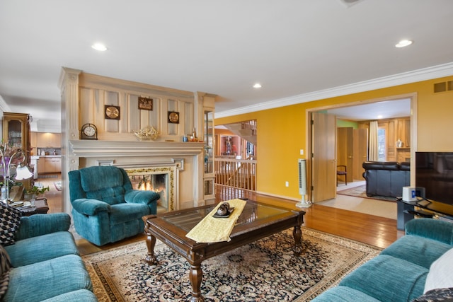 living room with ornamental molding and light wood-type flooring