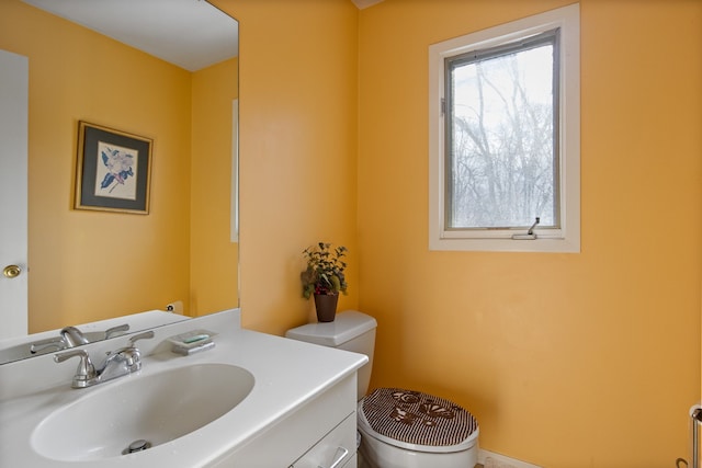 bathroom featuring vanity and toilet