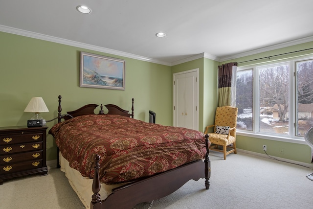 carpeted bedroom featuring ornamental molding and a closet