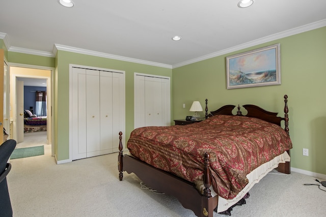 bedroom featuring multiple closets, ornamental molding, and light colored carpet