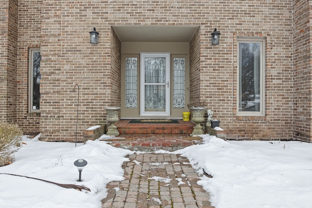 view of snow covered property entrance