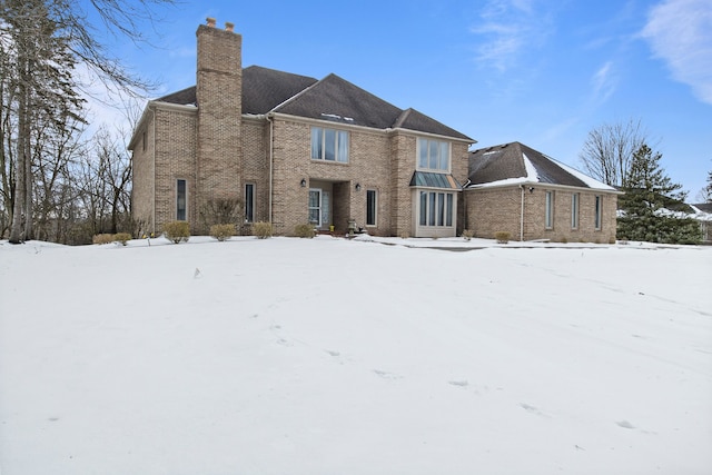 view of snow covered rear of property