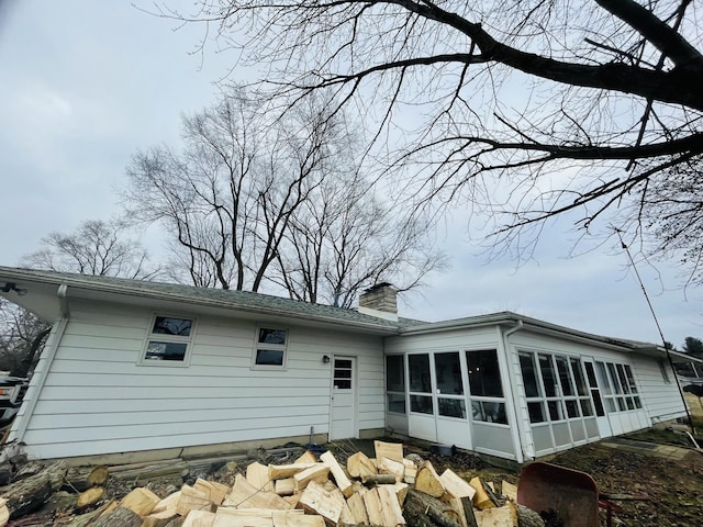 back of property with a sunroom