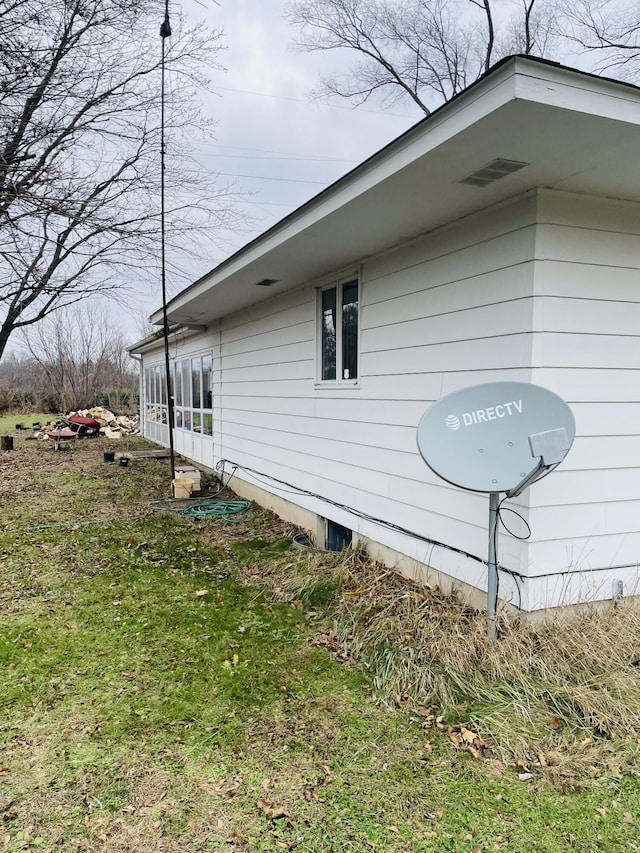 view of side of property with a yard