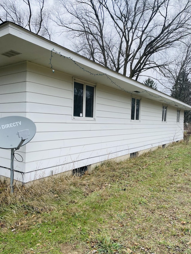 view of property exterior with a yard