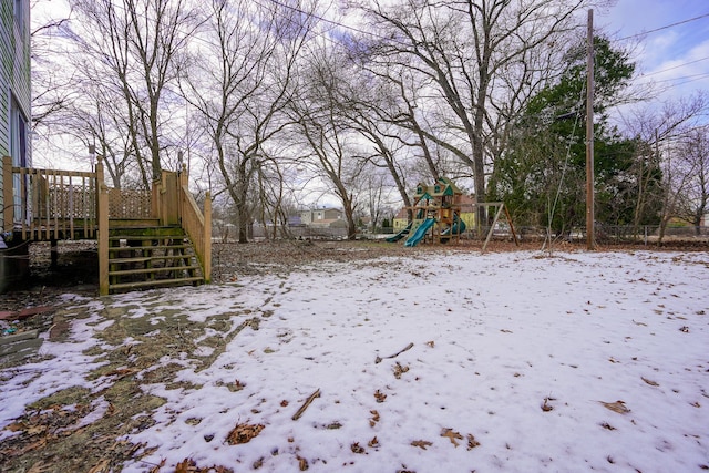 yard layered in snow with a playground