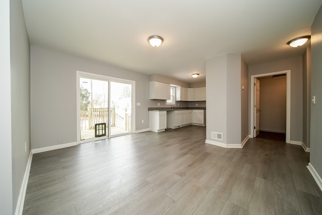 unfurnished living room with light wood-type flooring