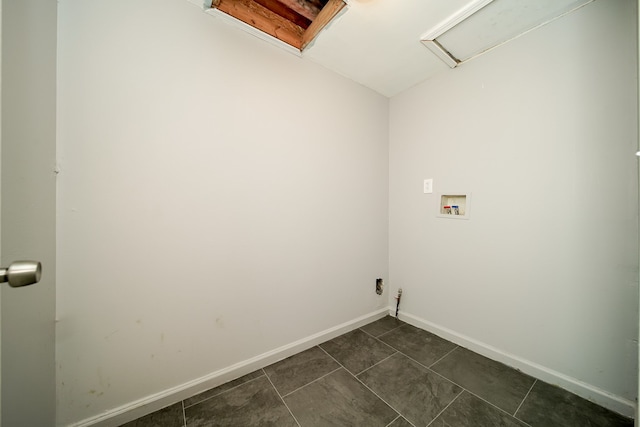 clothes washing area featuring washer hookup and dark tile patterned floors