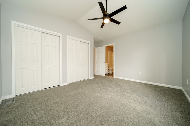 unfurnished bedroom featuring lofted ceiling, two closets, ceiling fan, and carpet