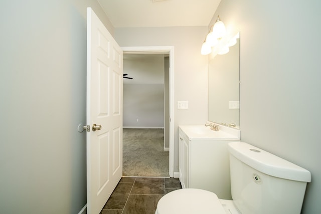 bathroom with vanity, tile patterned flooring, and toilet