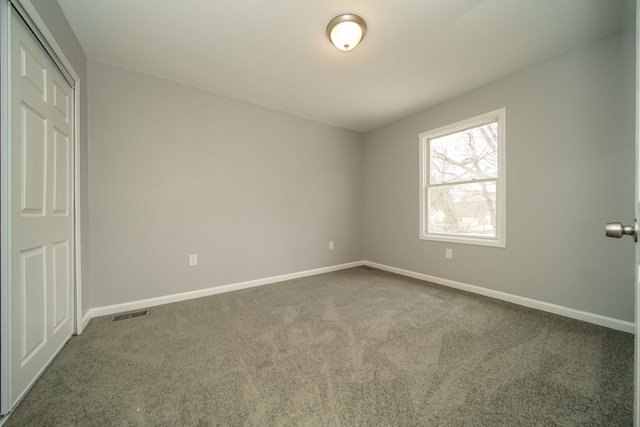 unfurnished bedroom featuring carpet and a closet